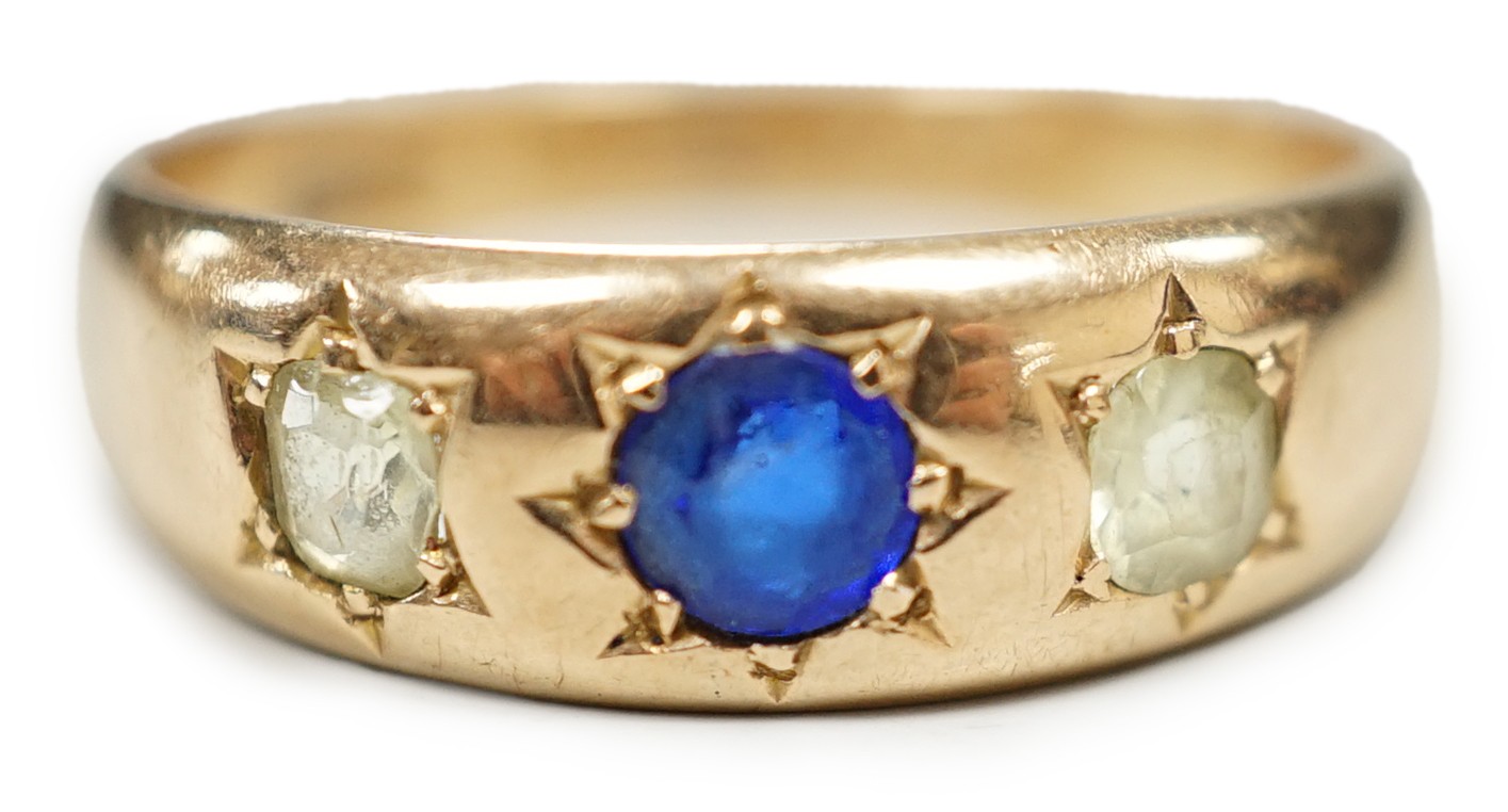A late Victorian 15ct gold and gypsy set three stone gem set ring, size Q/R, gross weight 4.3 grams.